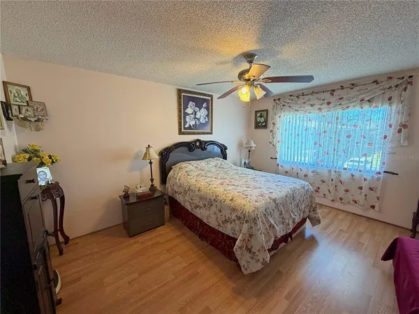 a bedroom with a bed dresser and a window