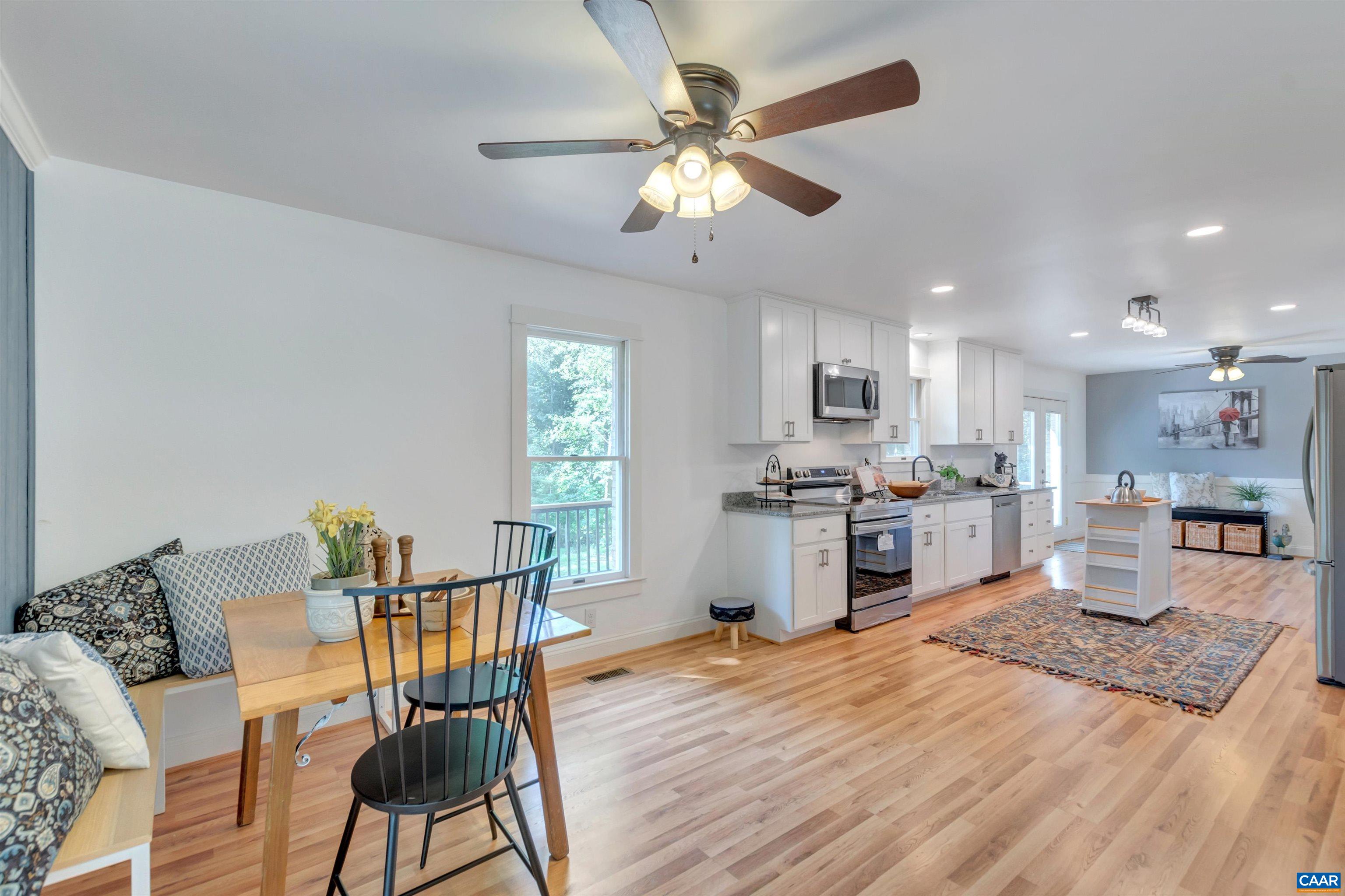 1820 Ridge Road Palmyra, VA 22963 - Photo 11 of 65 a open kitchen with stainless steel appliances granite countertop a stove top oven a sink dishwasher a dining table and chairs with wooden floor