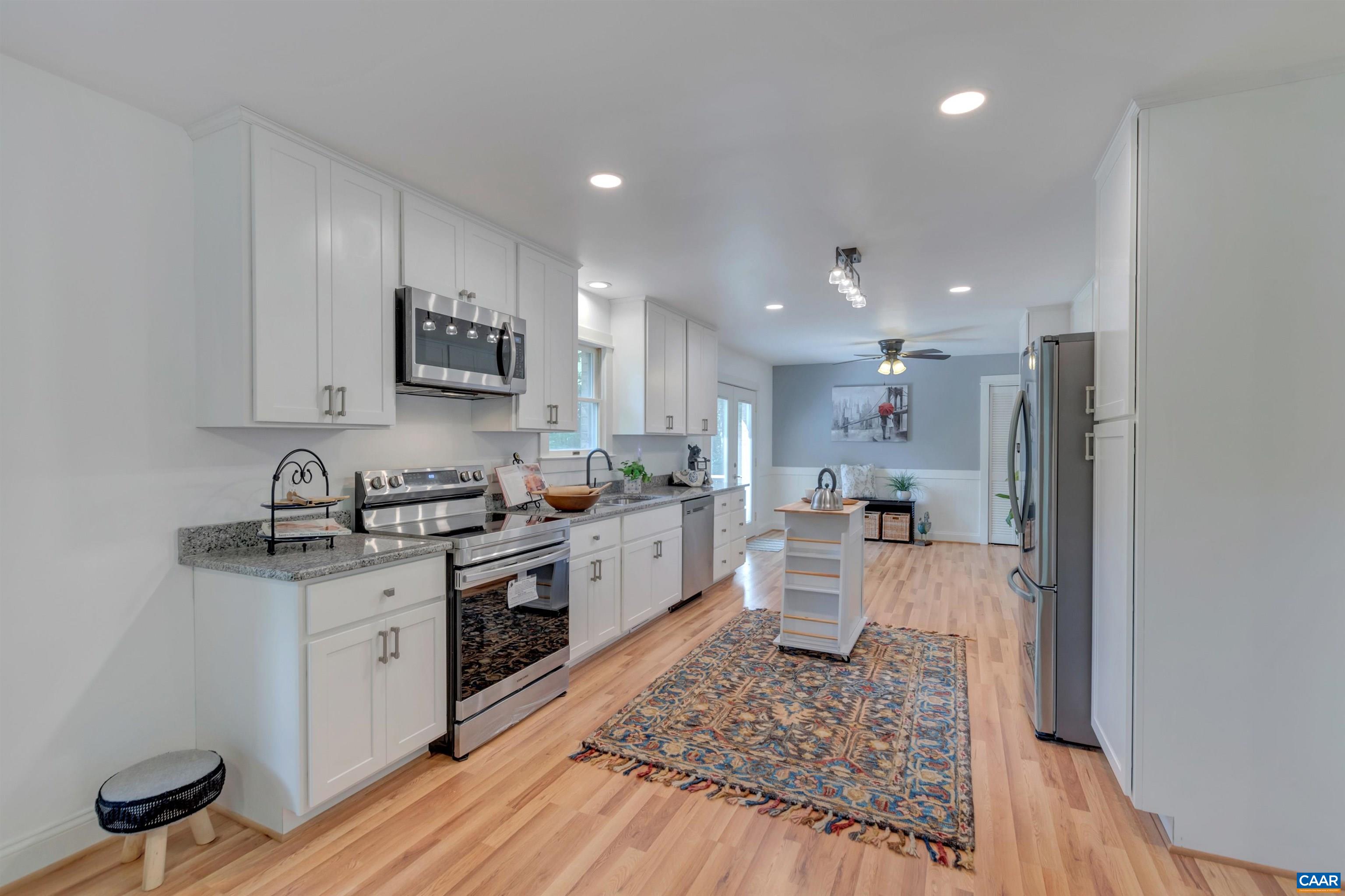 1820 Ridge Road Palmyra, VA 22963 - Photo 13 of 65 a large kitchen with stainless steel appliances granite countertop a stove a sink dishwasher and a refrigerator with wooden floor