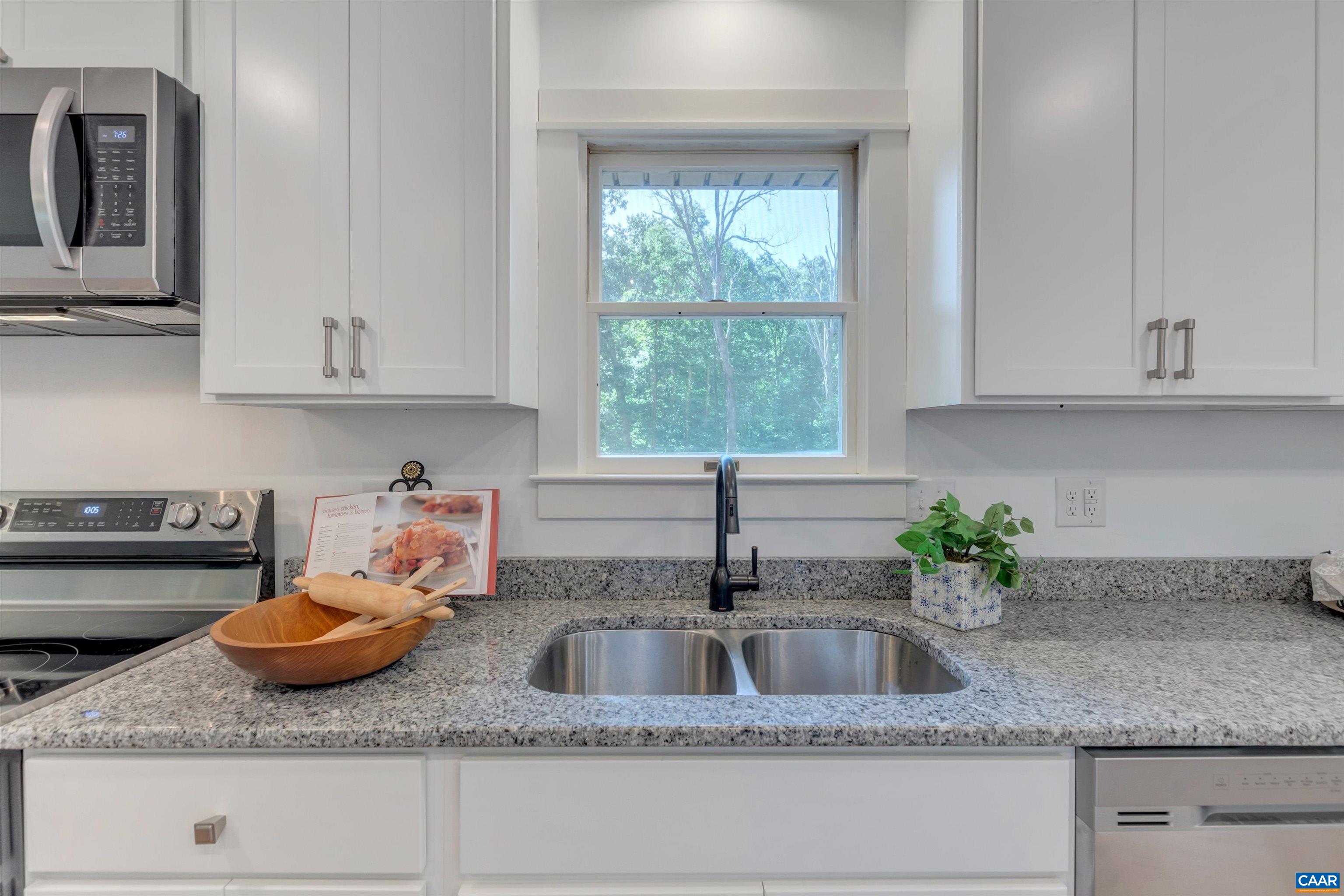 1820 Ridge Road Palmyra, VA 22963 - Photo 18 of 65 a kitchen with granite countertop a sink a window and cabinets