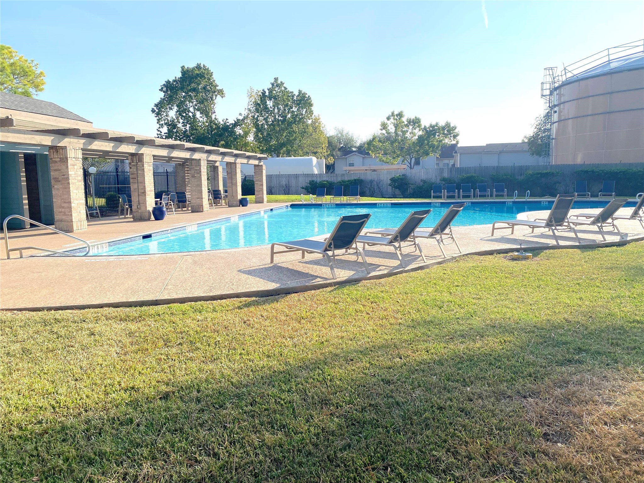3166 Windchase Boulevard, Unit 465 Houston, TX 77082 - Photo 18 of 21 a view of a house with swimming pool and a yard