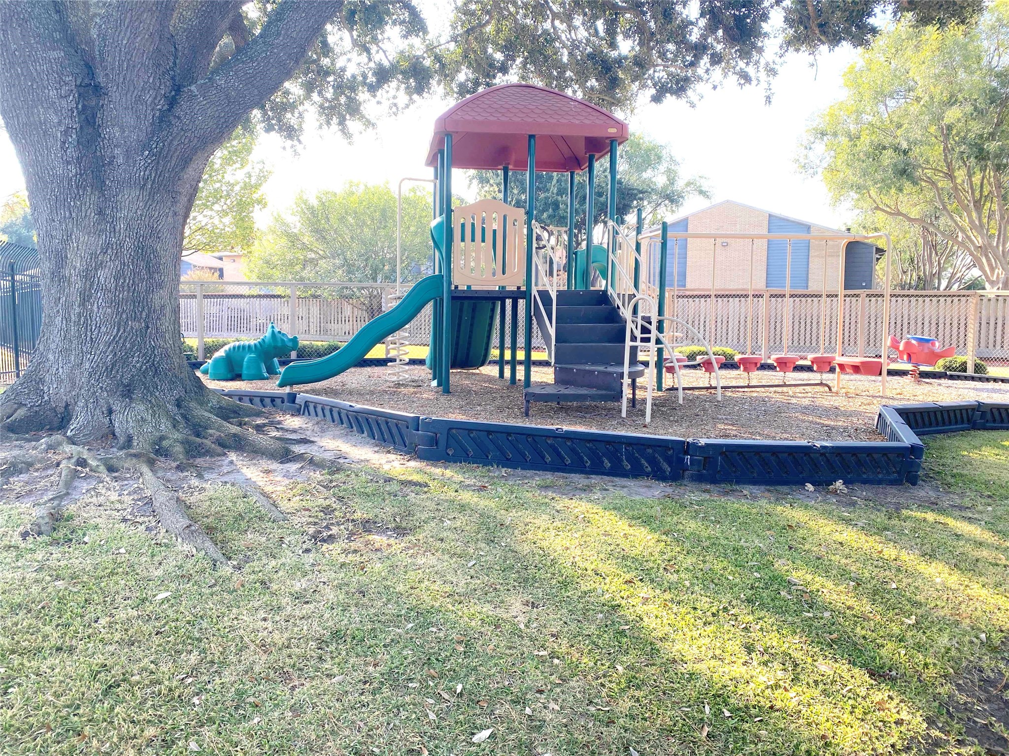 3166 Windchase Boulevard, Unit 465 Houston, TX 77082 - Photo 19 of 21 a small pool with a table and chairs under an umbrella