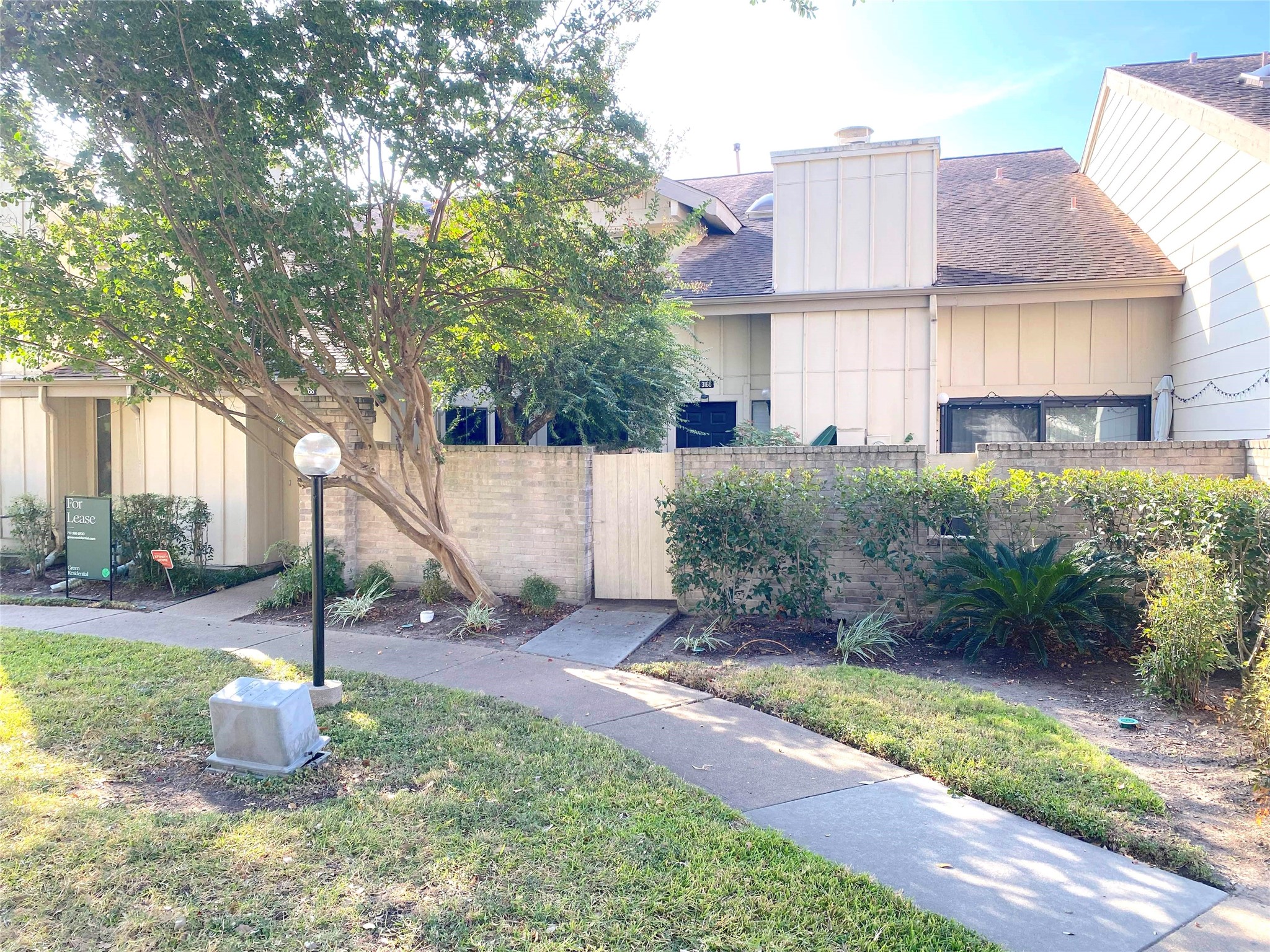 3166 Windchase Boulevard, Unit 465 Houston, TX 77082 - Photo 2 of 21 a front view of a house with a yard