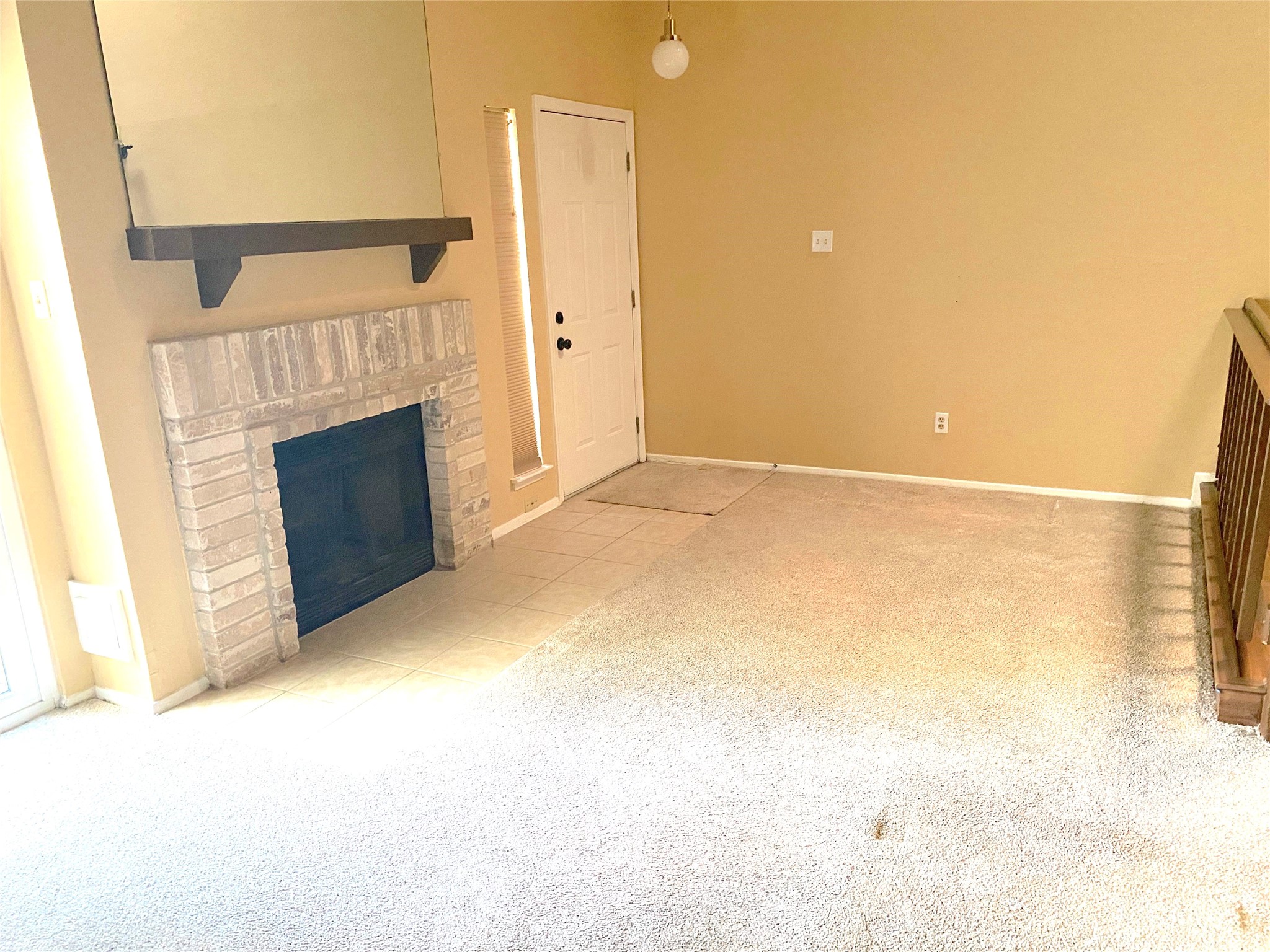 3166 Windchase Boulevard, Unit 465 Houston, TX 77082 - Photo 5 of 21 a view of empty room with fireplace and wooden floor