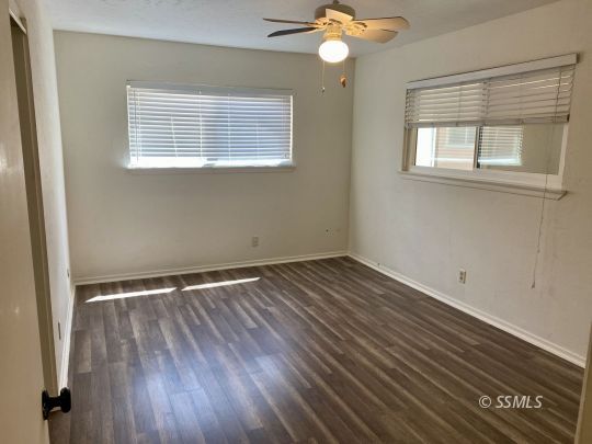 225 West Benson Avenue Ridgecrest, CA 93555 - Photo 10 of 20 a view of an empty room with wooden floor and a window