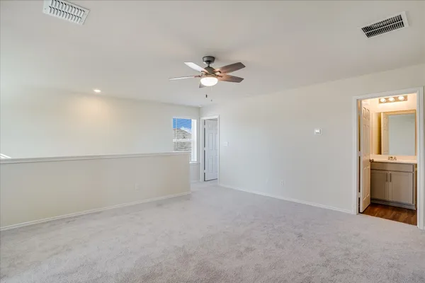 wooden floor in an empty room with a ceiling fan