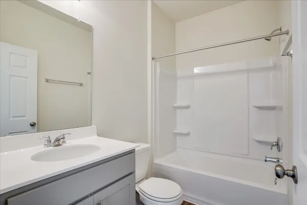 a bathroom with a sink toilet tub vanity and shower