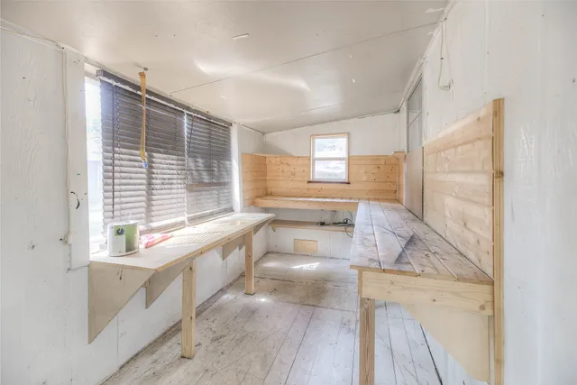 a large white kitchen with a large window