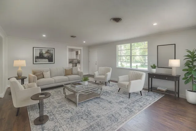a living room with furniture and wooden floor