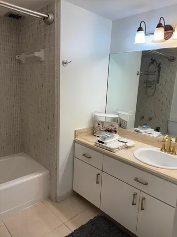 a bathroom with a tub sink and mirror