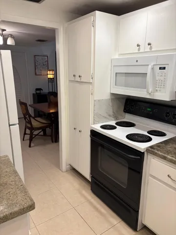a kitchen with a stove and a refrigerator