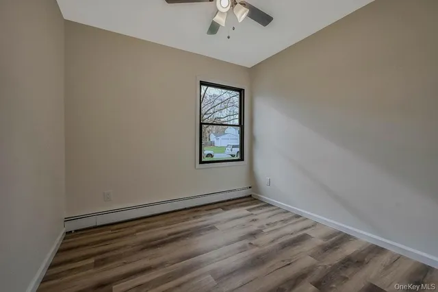 wooden floor in an empty room with a window