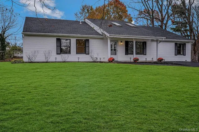 a front view of a house with a garden