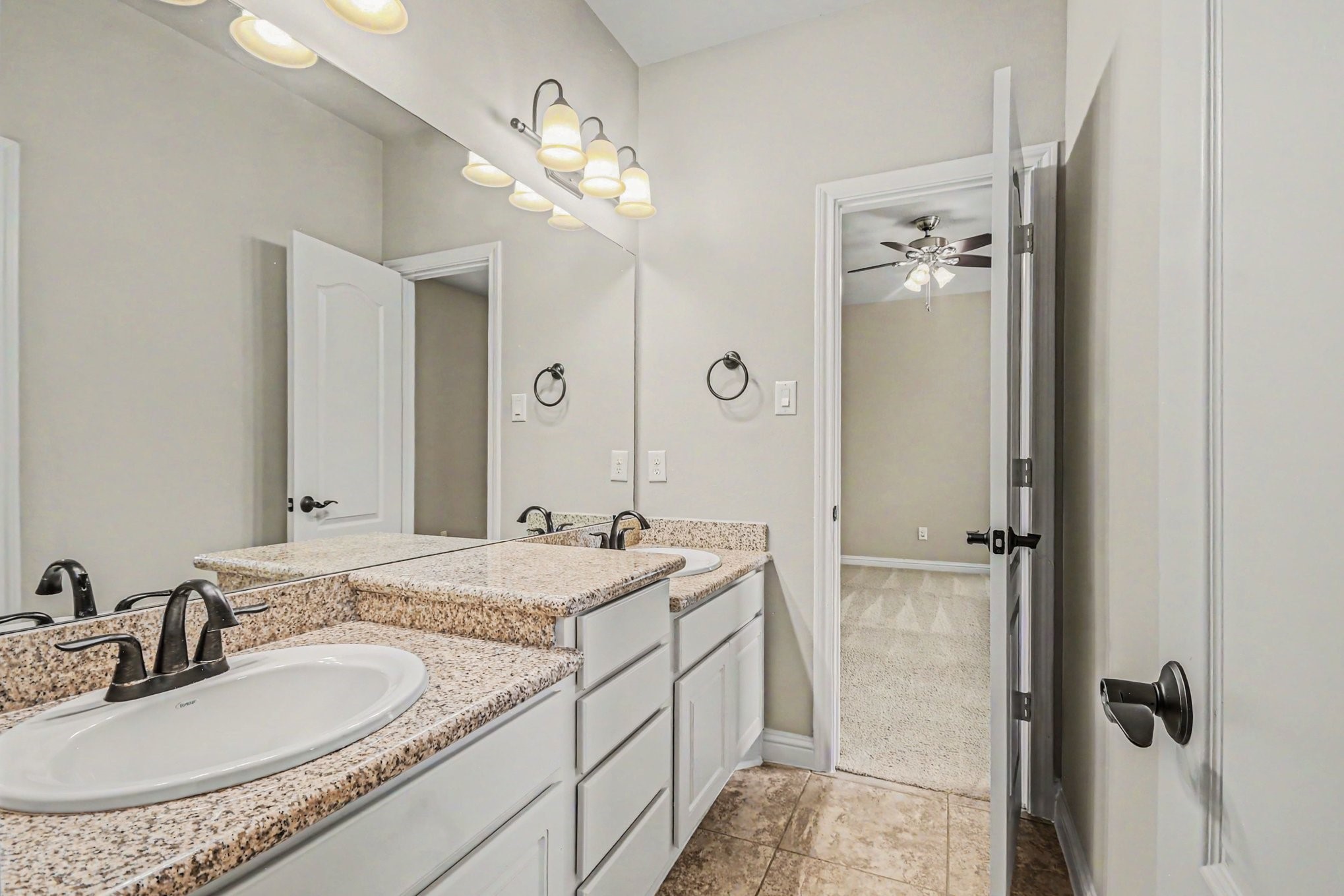 3310 Ralston Edge Lane Houston, TX 77059 - Photo 43 of 50 a bathroom with a granite countertop sink a mirror and shower