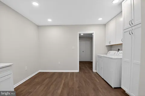 a view of a kitchen with wooden floor and electronic appliances