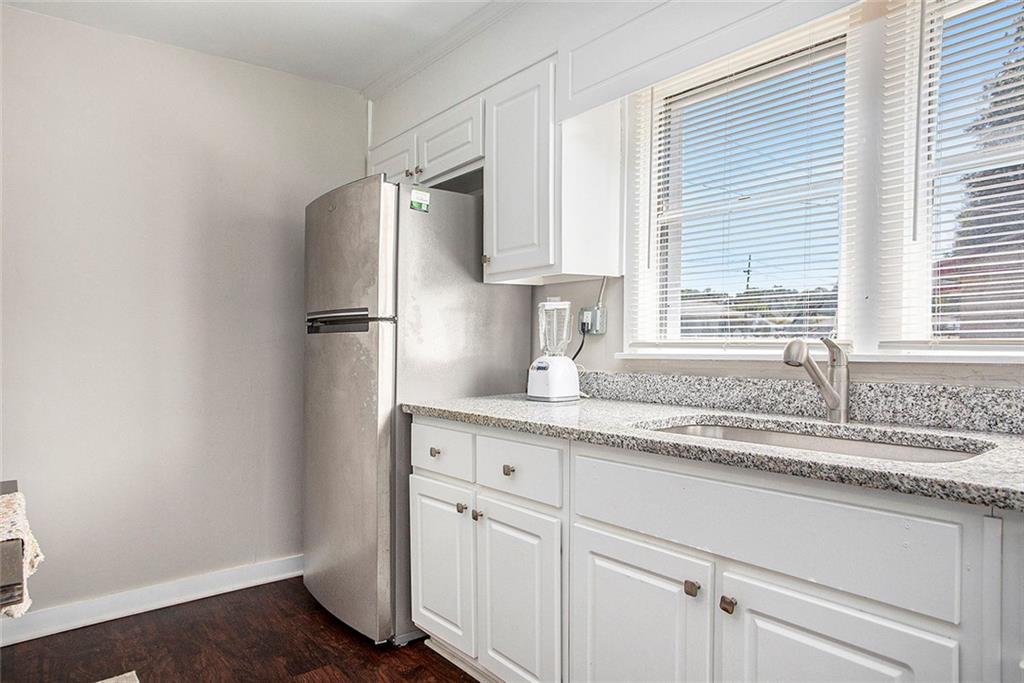 1298 Irwin Bridge Road Northwest Conyers, GA 30012 - Photo 11 of 25 a kitchen with stainless steel appliances granite countertop a sink and a refrigerator