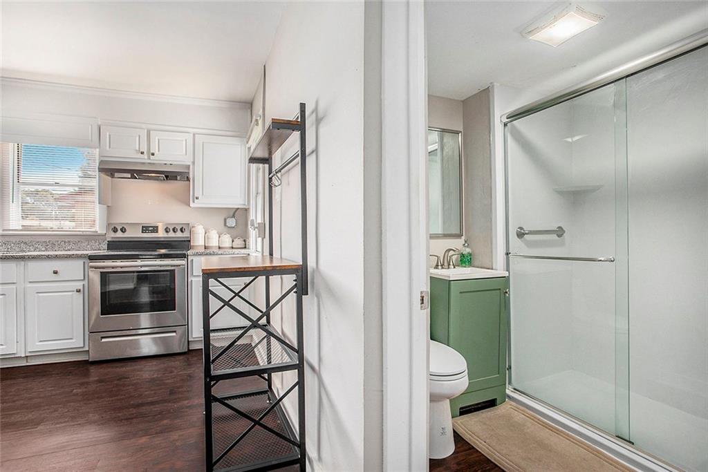 1298 Irwin Bridge Road Northwest Conyers, GA 30012 - Photo 14 of 25 a kitchen with a stove a refrigerator and a sink