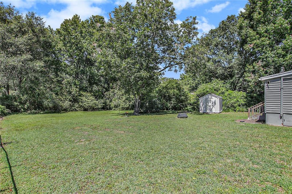 1298 Irwin Bridge Road Northwest Conyers, GA 30012 - Photo 23 of 25 a house with a yard
