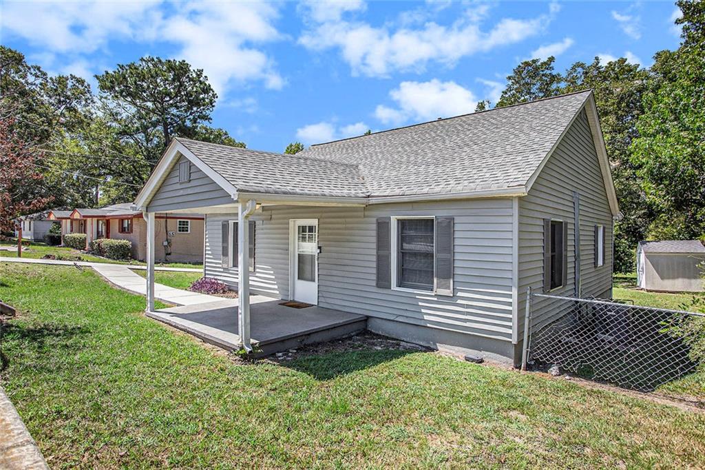 1298 Irwin Bridge Road Northwest Conyers, GA 30012 - Photo 3 of 25 a view of a house with a chairs in a yard