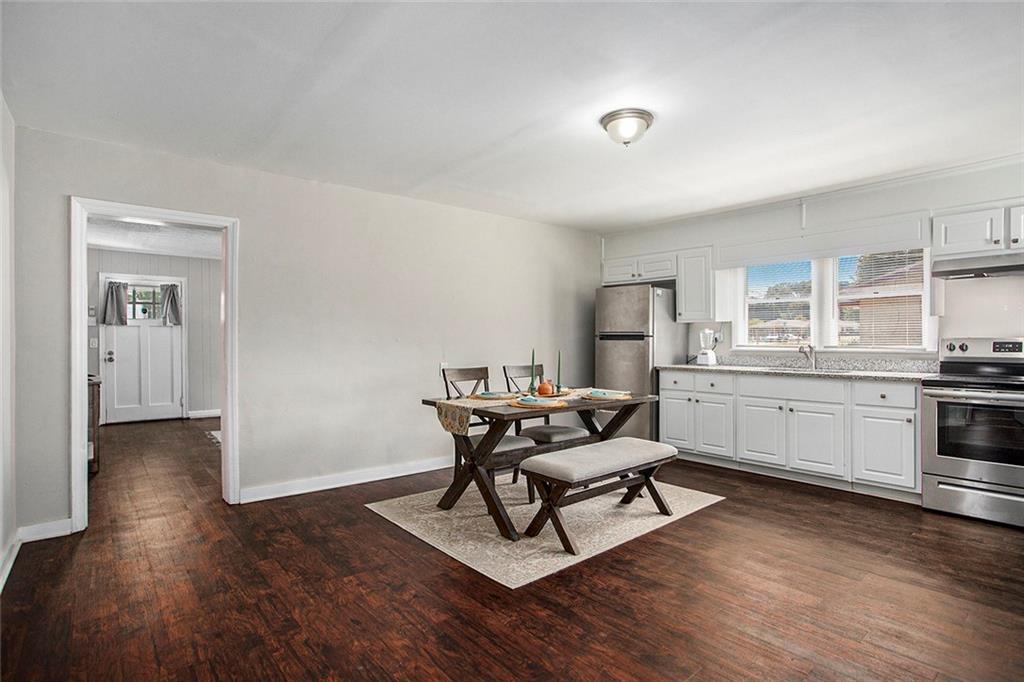 1298 Irwin Bridge Road Northwest Conyers, GA 30012 - Photo 8 of 25 a living room with furniture and a wooden floor