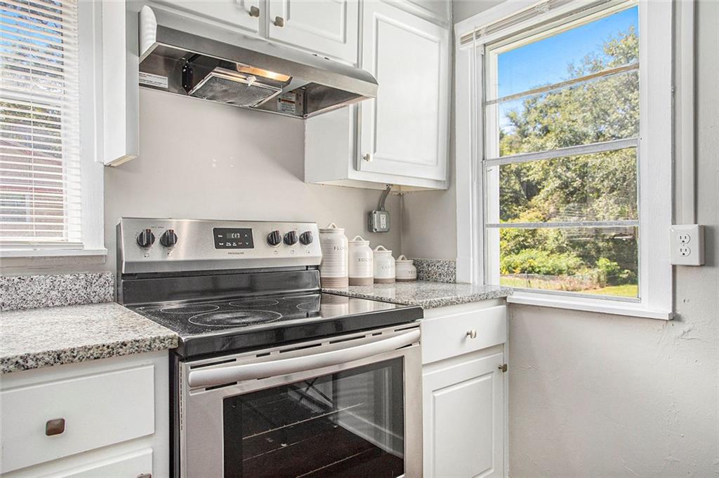1298 Irwin Bridge Road Northwest Conyers, GA 30012 - Photo 10 of 25 a stove top oven sitting inside of a kitchen