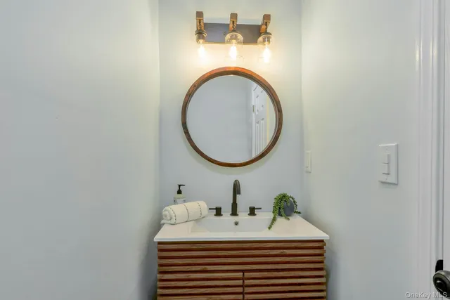 a kitchen with stainless steel appliances granite countertop a stove top oven a sink dishwasher and white cabinets with wooden floor