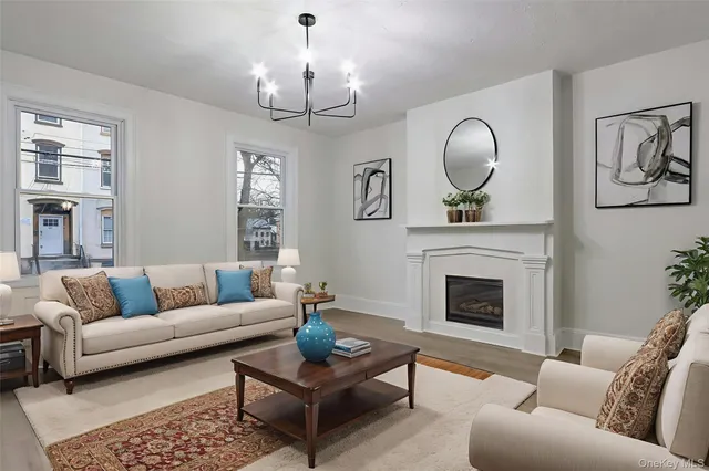 a view of a room with wooden floor and chandelier