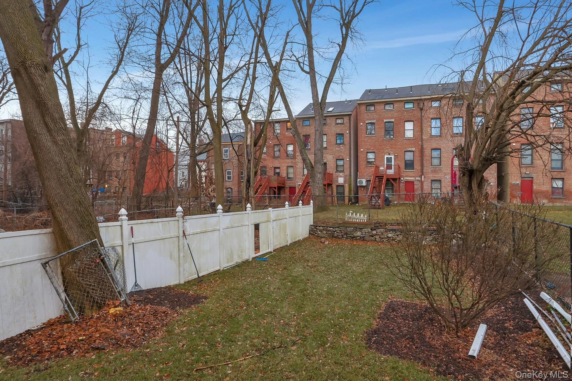 171 Chambers Street Newburgh, NY 12550 - Photo 38 of 39 a view of a large white building in the middle of a yard