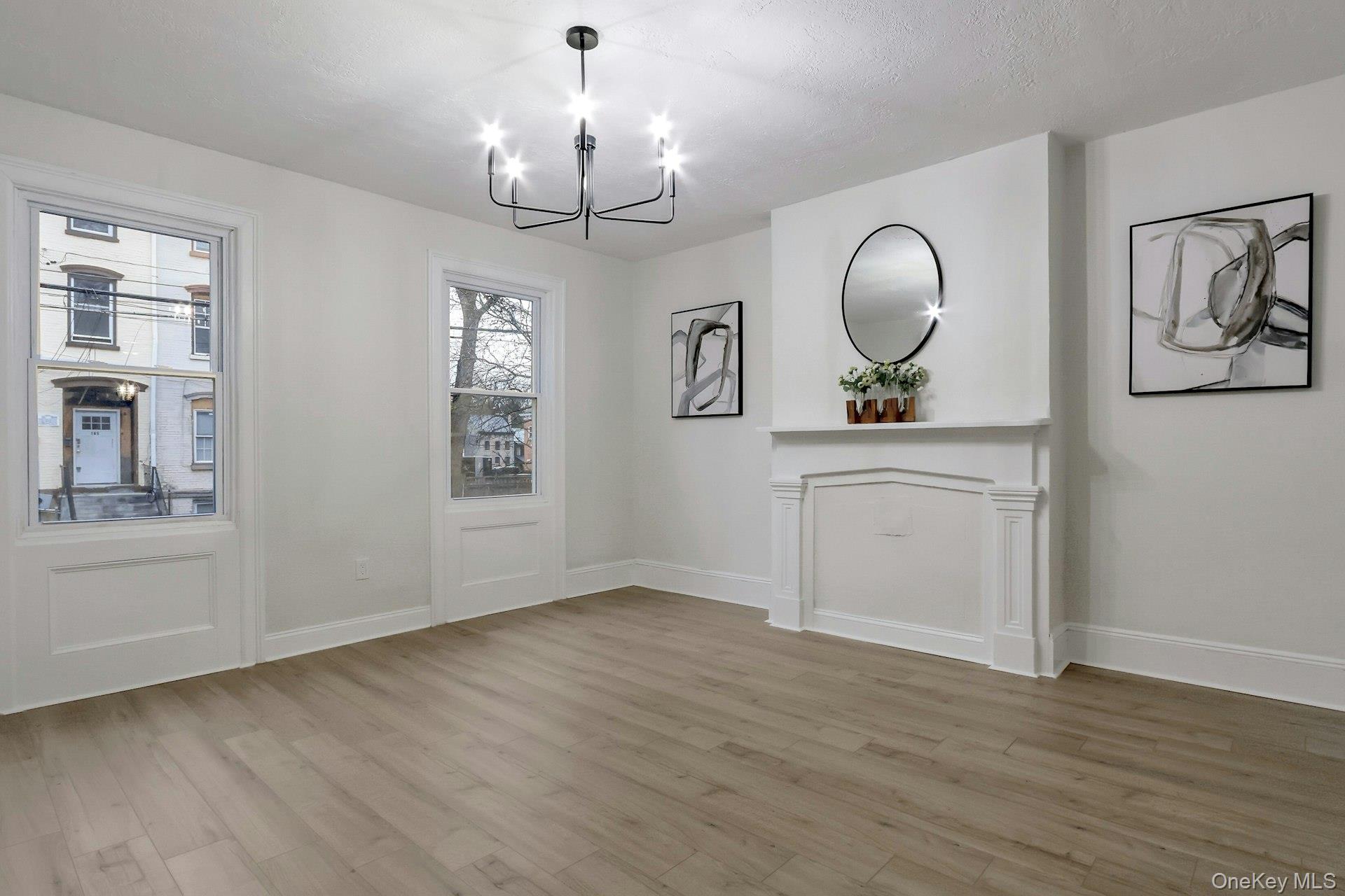 171 Chambers Street Newburgh, NY 12550 - Photo 4 of 39 a view of a room with wooden floor and chandelier