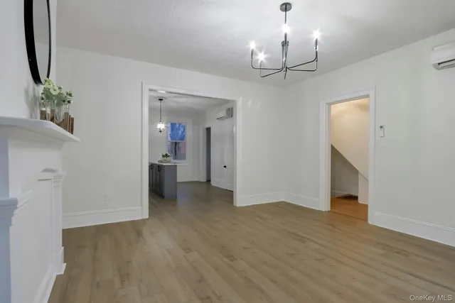 a kitchen with kitchen island granite countertop a sink cabinets and wooden floor