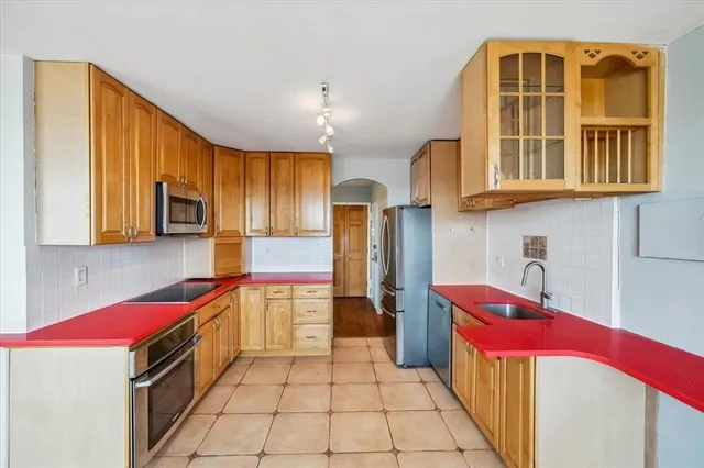 a kitchen with a refrigerator a sink and dishwasher