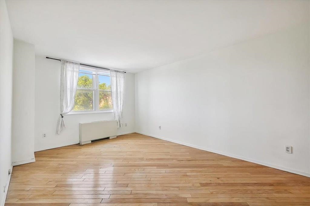 380 Mountain Road, Unit 213 Union City, NJ 07087 - Photo 15 of 24 an empty room with wooden floor and windows