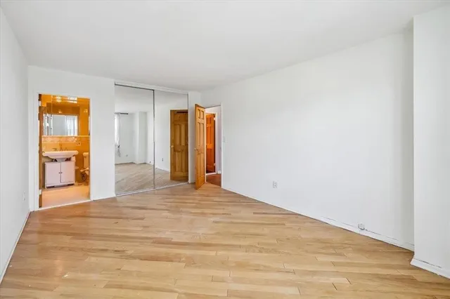 a view of an empty room and wooden floor