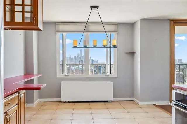 a view of a livingroom with wooden floor and windows