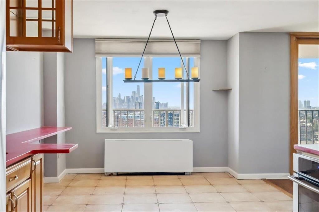 380 Mountain Road, Unit 213 Union City, NJ 07087 - Photo 10 of 24 a view of a livingroom with wooden floor and windows