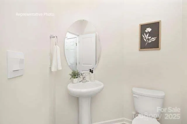 a bathroom with a sink a toilet and mirror