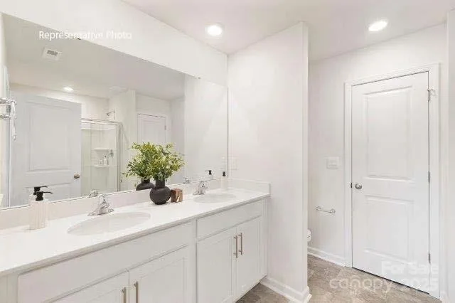 a bathroom with double sink and a mirror