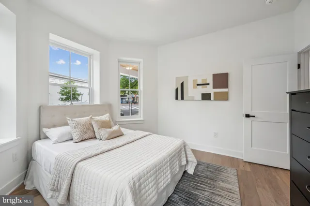 a bedroom with a large bed and a window