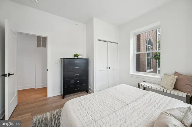 a bedroom with a bed and a dresser