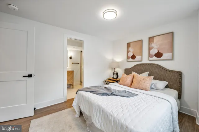 a bedroom with a bed and a painting on the wall