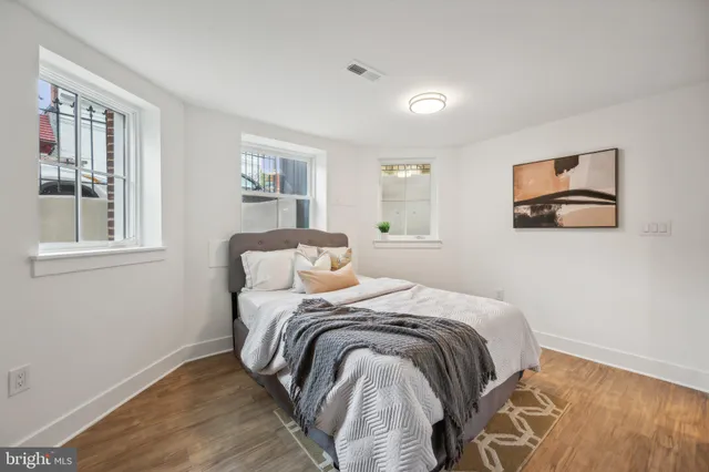 a bed sitting in a bedroom next to a window