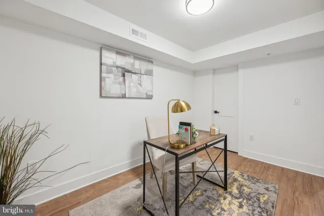 a workspace room with furniture and wooden floor