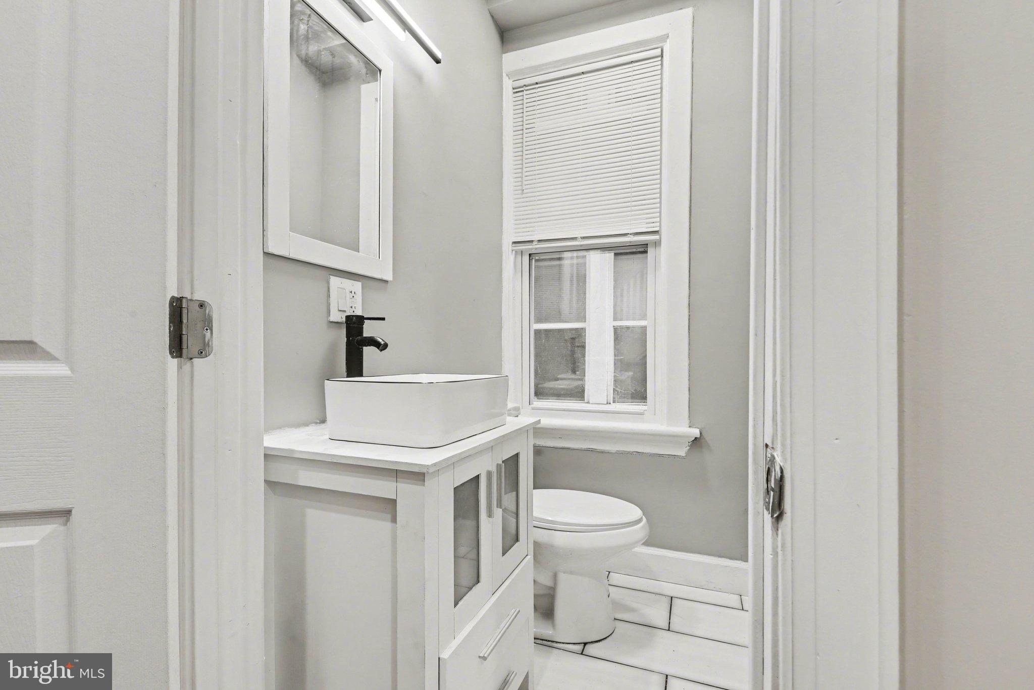 918 North 16th Street Harrisburg, PA 17103 - Photo 11 of 31 a white toilet sitting next to a bathroom sink