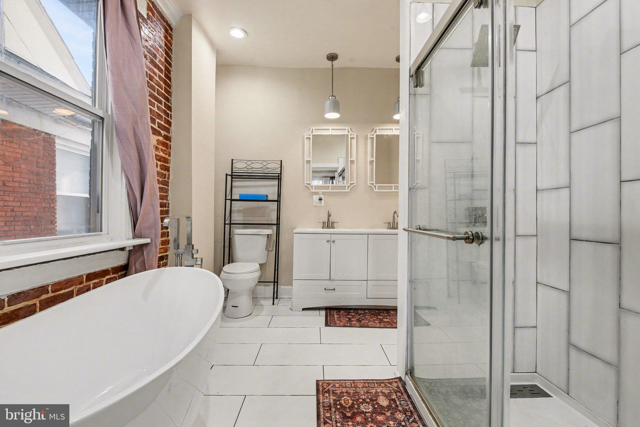 918 North 16th Street Harrisburg, PA 17103 - Photo 14 of 31 a bathroom with a bathtub and a shower