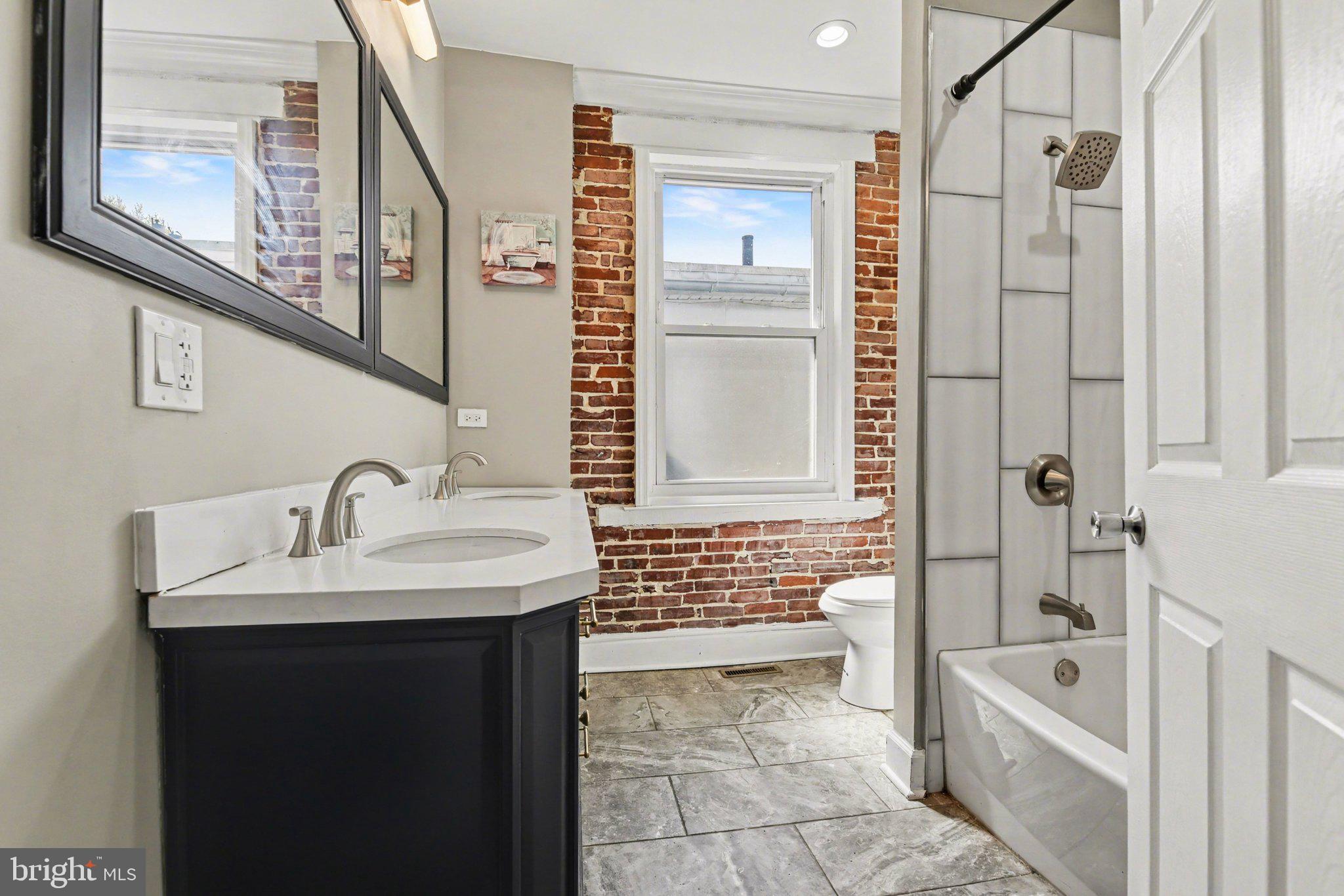 918 North 16th Street Harrisburg, PA 17103 - Photo 16 of 31 a bathroom with a sink a mirror and a bathtub
