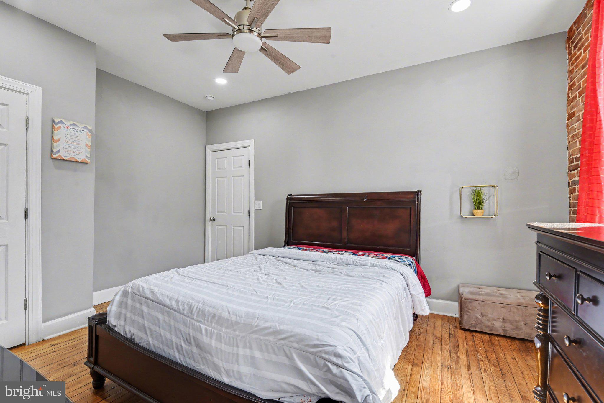 918 North 16th Street Harrisburg, PA 17103 - Photo 18 of 31 a bedroom with a bed and wooden floor