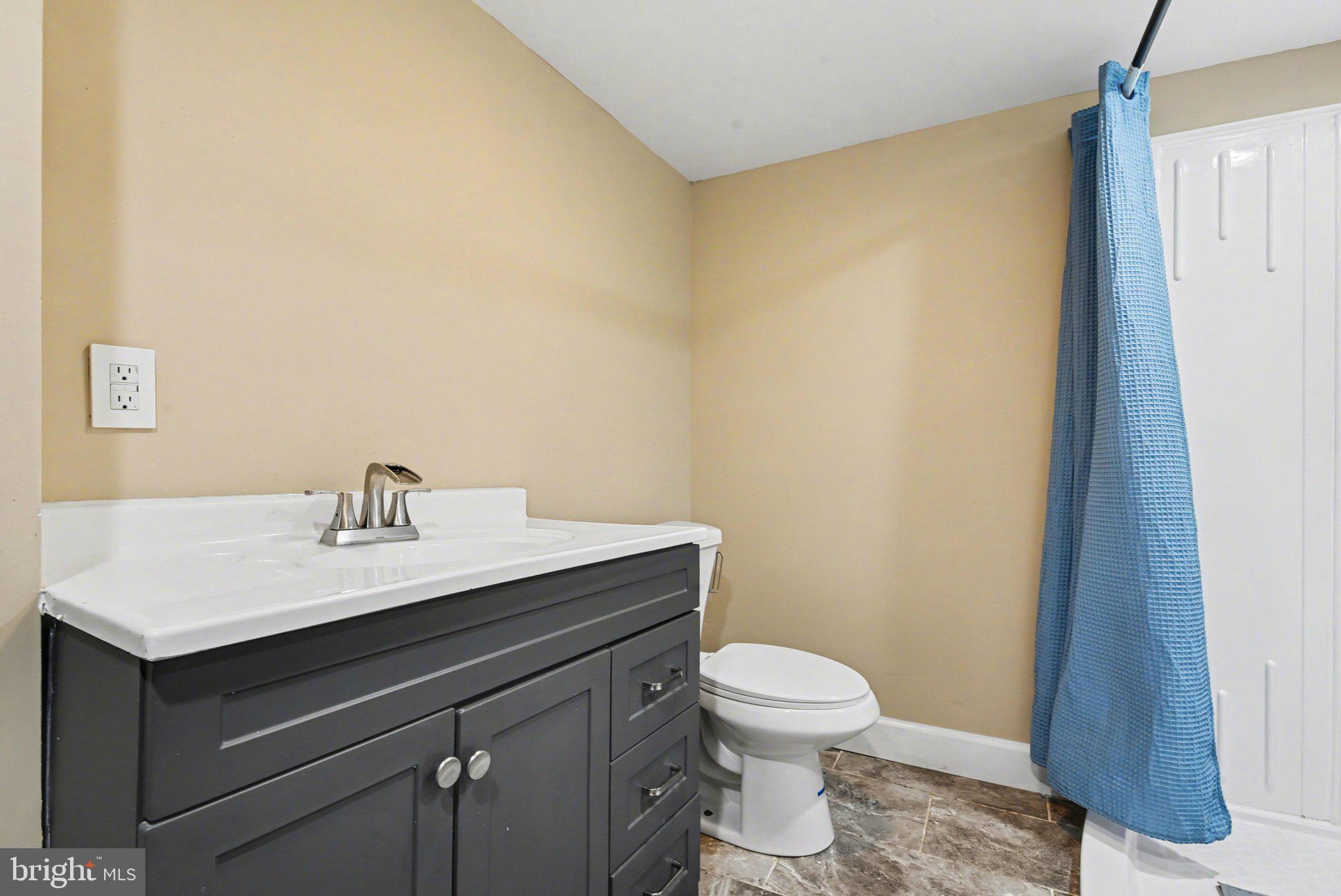 918 North 16th Street Harrisburg, PA 17103 - Photo 27 of 31 a bathroom with a sink a toilet and a mirror