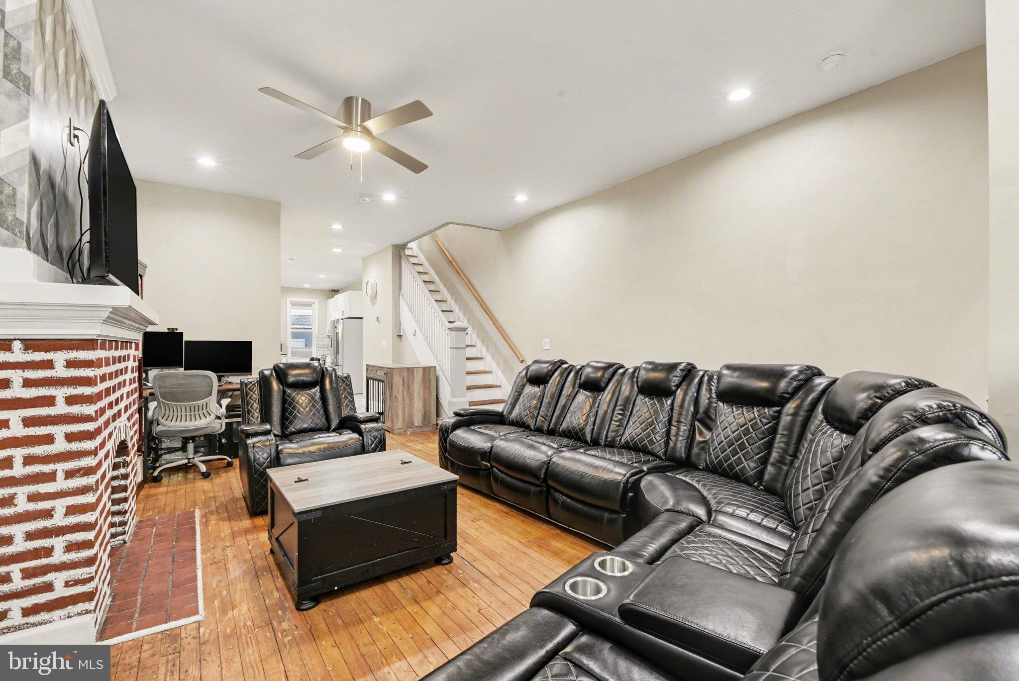 918 North 16th Street Harrisburg, PA 17103 - Photo 5 of 31 a living room with couches and kitchen view with wooden floor