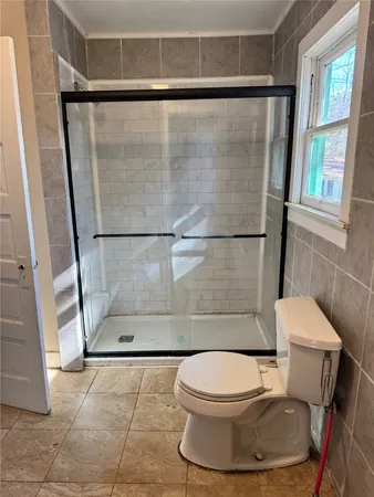 a bathroom with a toilet and a shower