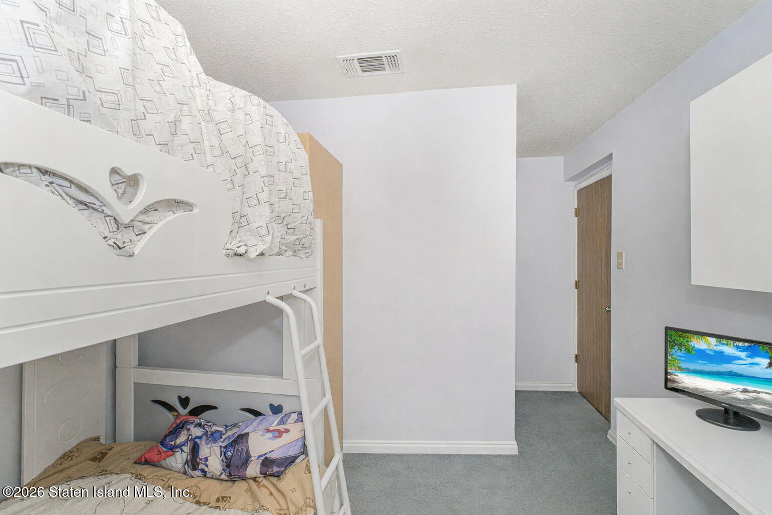 212 Ilyssa Way Staten Island, NY 10312 - Photo 13 of 21 a bed room with a bed and a television